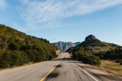 Road amidst mountains against sky