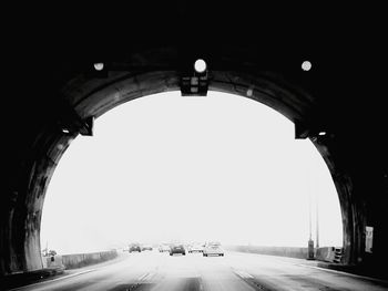 Cars on road in city against clear sky