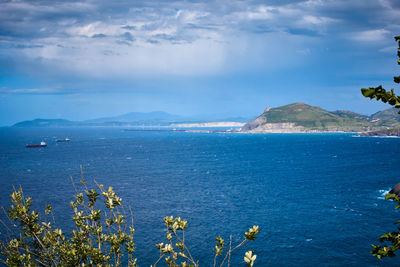 Scenic view of sea against cloudy sky