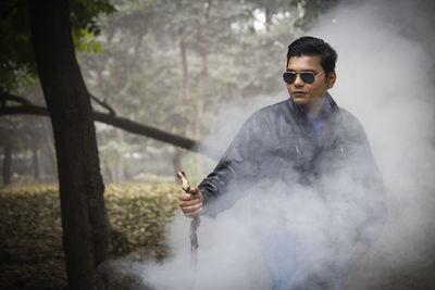 Man wearing sunglasses standing outdoors