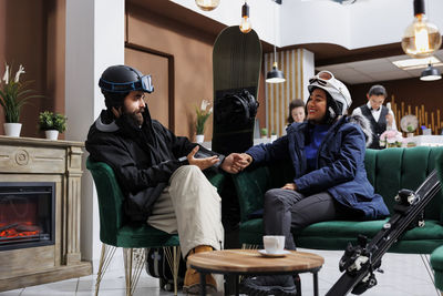 Friends using digital tablet while sitting at home