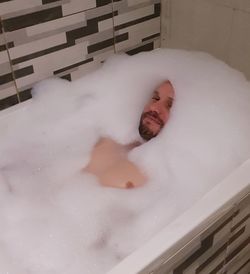 Reflection of man in bathtub