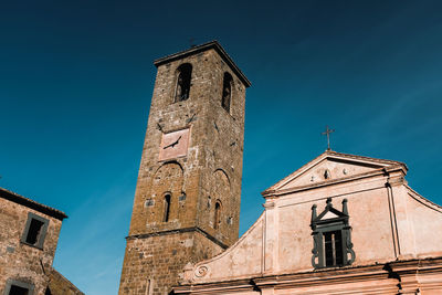 Low angle view of old building against blue sky