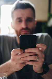 Midsection of man using mobile phone