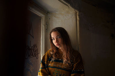 Woman standing against wall