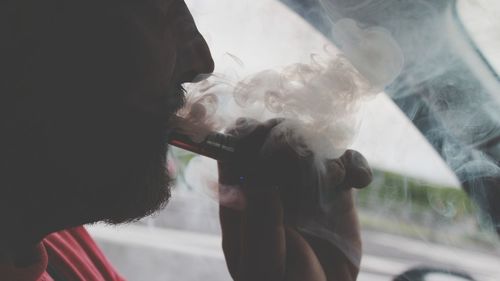 Close-up of man smoking electronic cigarette