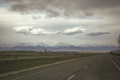 Road by landscape against sky