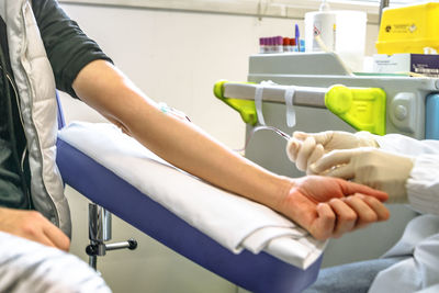 Doctor giving treatment to patient at hospital