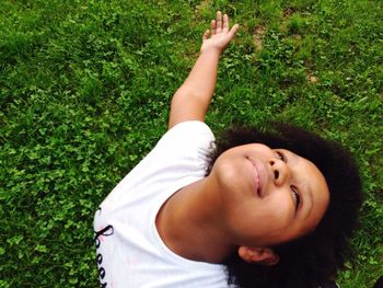 Portrait of cute boy lying on grass