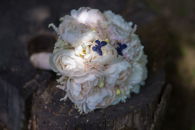 Close-up of artificial butterflies on peony flowers bouquet