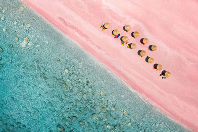 High angle view of sun umbrellas on pink beach by the sea