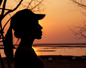 Portrait of silhouette woman looking at sunset