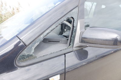 Glass of a car broken by vandals to steal inside.