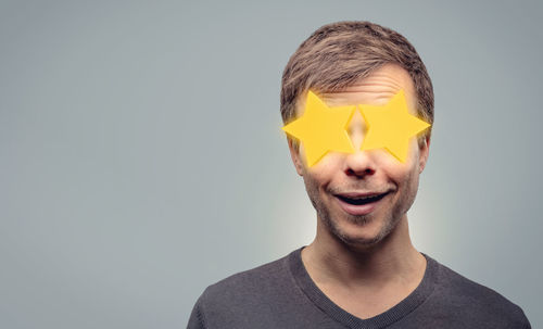 Portrait of smiling man against gray background