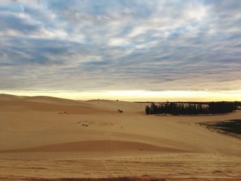 Scenic view of desert against sky during sunset