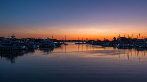 Sailboats in marina at sunset