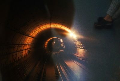 Low section of illuminated tunnel at subway station