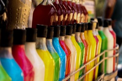 Close-up of colorful bottles at market stall