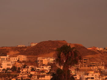 Buildings in town against clear sky