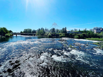 Scenic view of lake against clear blue sky