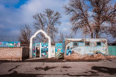 Graffiti on wall of house against sky