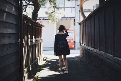 Full length of woman walking on footpath