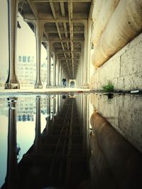 Low angle view of man riding bicycle on pont de bir-hakeim