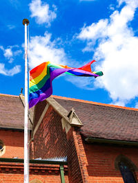 Low angle view of flags against sky