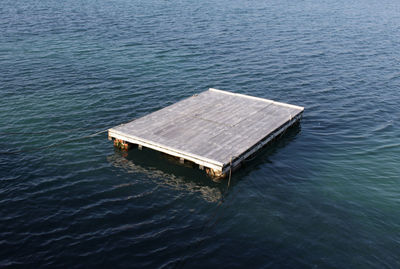 High angle view of wooden raft floating on water in sea