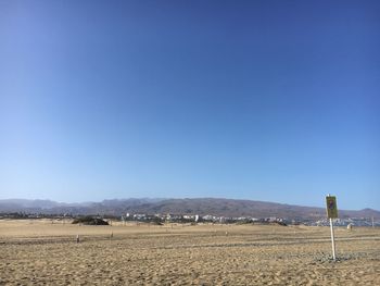 Scenic view of field against clear blue sky