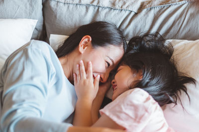 High angle view of woman sleeping on bed