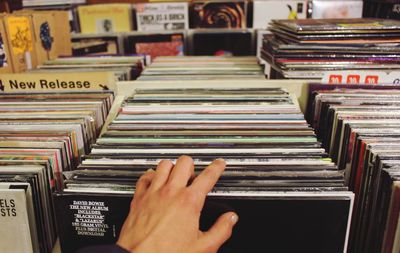 Cropped image of hand choosing record at store