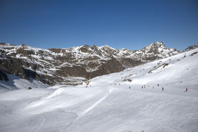 Scenic view of snow covered mountains against sky