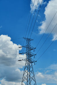 Low angle view of electricity pylon against sky