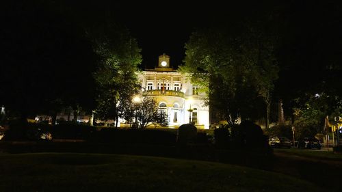 Illuminated building against sky at night