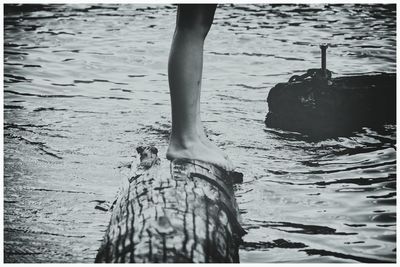 Low section of person standing on beach
