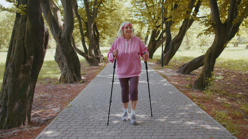 Low section of woman standing on footpath