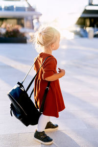 Rear view of woman standing outdoors