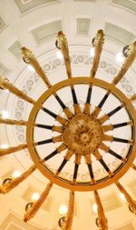 Low angle view of illuminated chandelier hanging in building