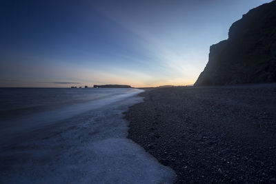 Scenic view of beach against sky during sunset
