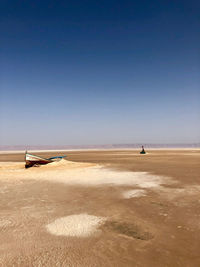 Scenic view of beach against clear blue sky