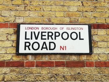 Close-up of text on brick wall