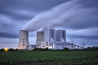 View of factory against cloudy sky