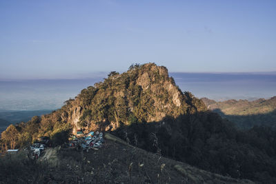 Scenic view of land and mountains against sky