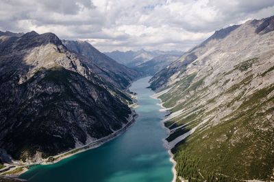 Scenic view of river amidst mountains against sky