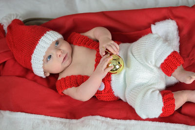 Portrait of a newborn baby in christmas clothes and santa hat