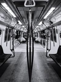 Train moving in illuminated underground walkway