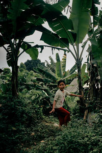 Full length of woman standing on tree