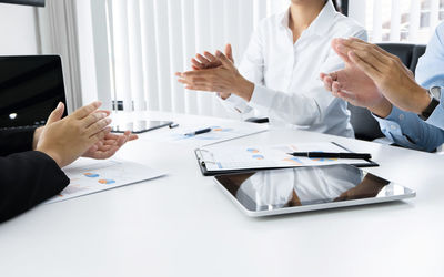 Group of people using laptop on table