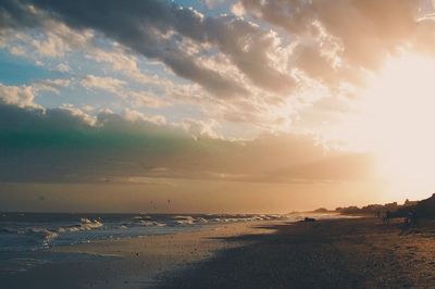 View of beach against cloudy sky